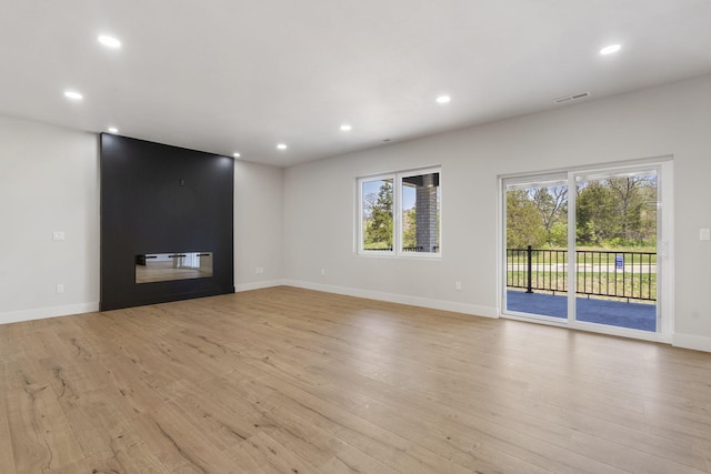 252 Hickory Hills Blvd, Springfield, MO 65802 - unfurnished living room with a wealth of natural light, light wood finished floors, visible vents, and recessed lighting