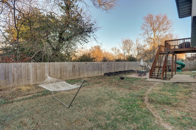 yard at dusk with a patio area and a playground