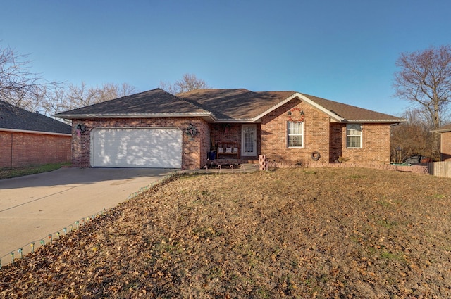 ranch-style home featuring a front lawn and a garage