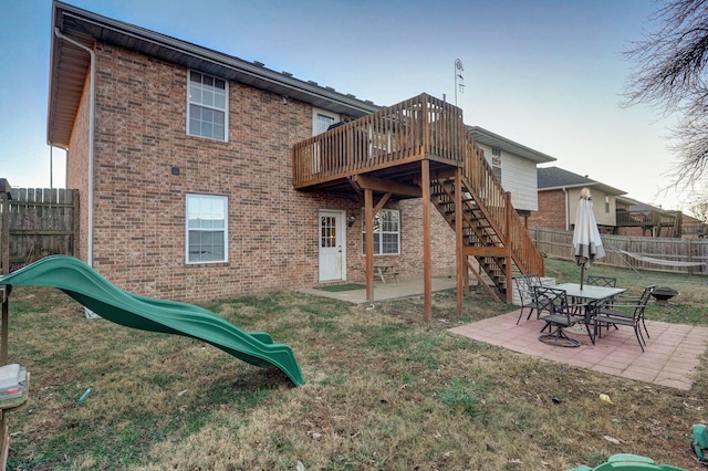 back of property with a yard and a patio