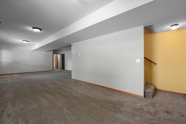 spare room featuring carpet flooring and a textured ceiling