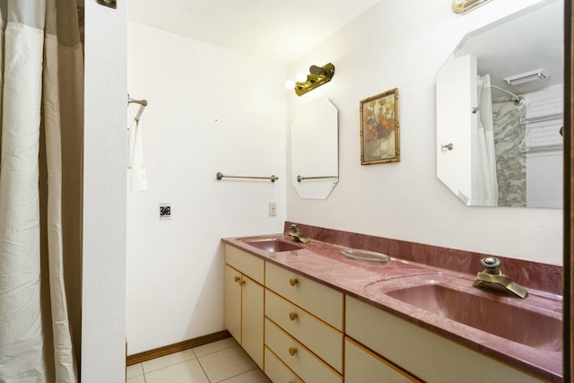 full bath with tile patterned flooring, curtained shower, double vanity, and a sink