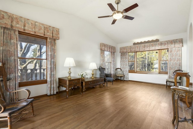 living area with ceiling fan, lofted ceiling, and wood finished floors