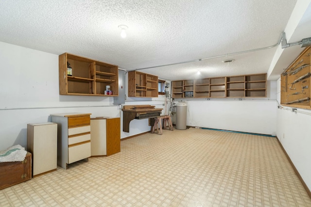 kitchen featuring a textured ceiling, baseboards, and open shelves