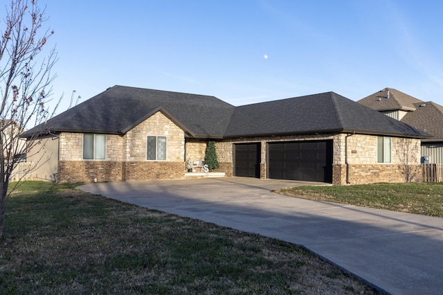 view of front of home featuring a garage and a front lawn