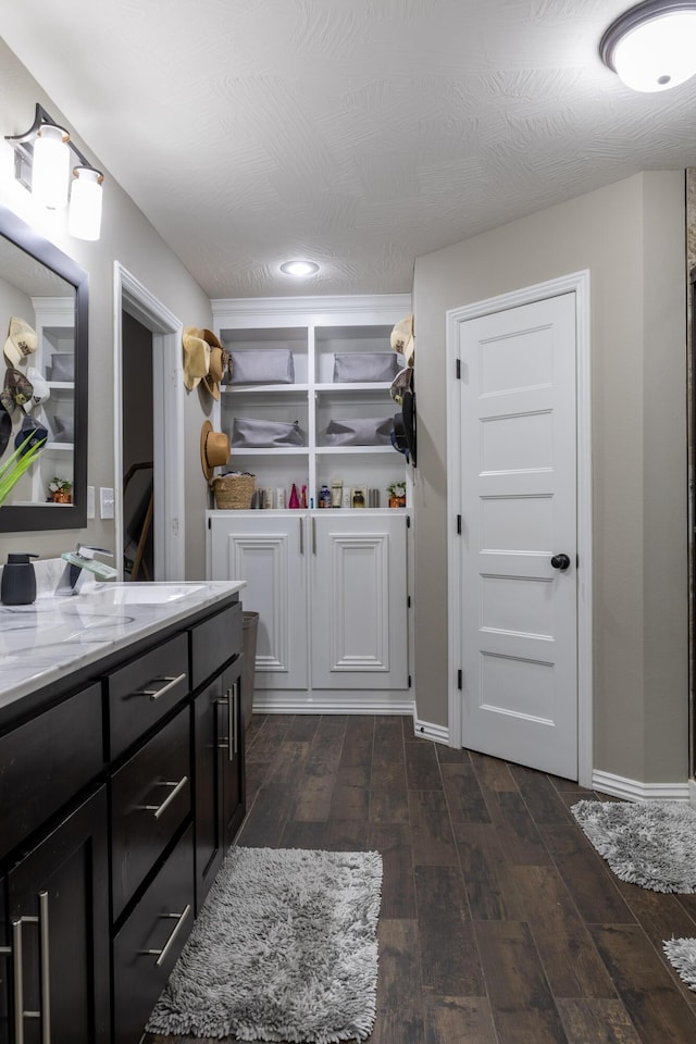 bathroom featuring vanity, wood-type flooring, and a textured ceiling