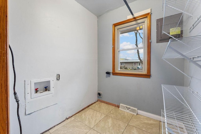 clothes washing area with electric dryer hookup, light tile patterned floors, and washer hookup