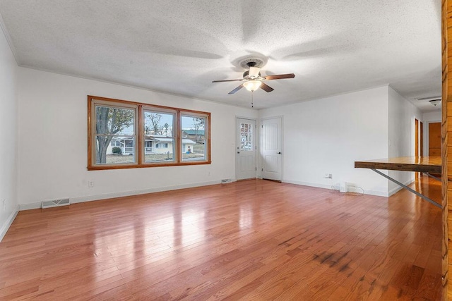 unfurnished living room featuring ceiling fan, light hardwood / wood-style floors, and a textured ceiling