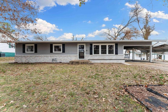 ranch-style house featuring central AC, a front yard, and a carport