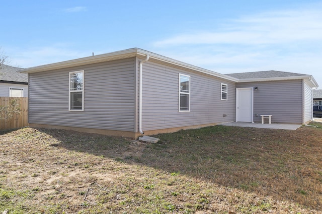 back of house featuring a yard