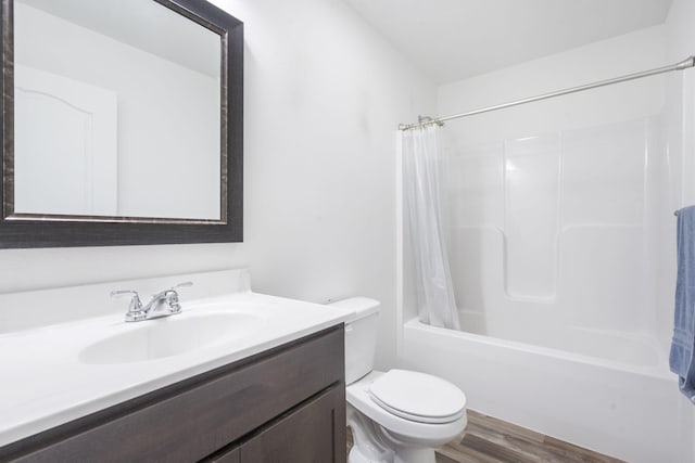 full bathroom with shower / tub combo with curtain, vanity, wood-type flooring, and toilet