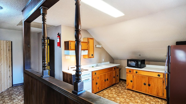 interior space featuring stainless steel fridge, a textured ceiling, sink, white stove, and lofted ceiling