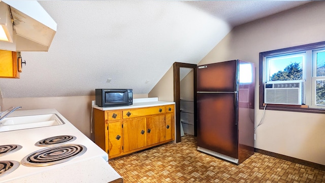 kitchen featuring exhaust hood, cooling unit, sink, vaulted ceiling, and fridge