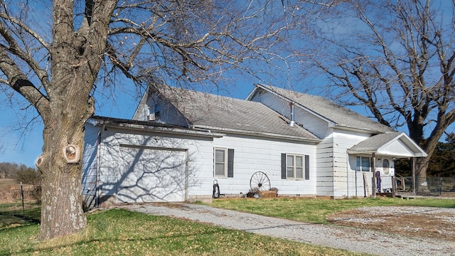 view of front of home with a front yard and a garage