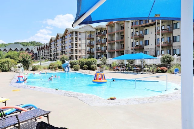 view of swimming pool featuring a patio and a water slide