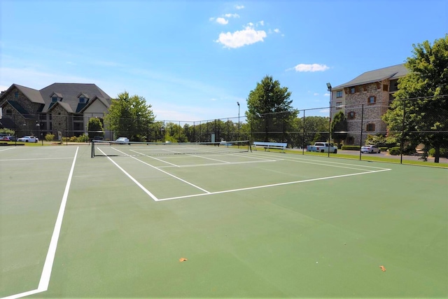 view of tennis court featuring basketball hoop