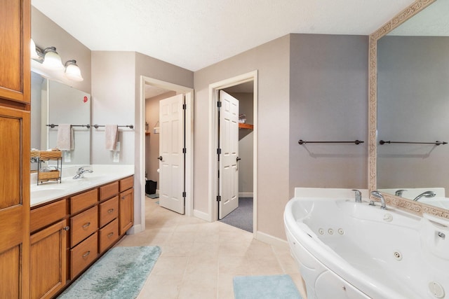 bathroom featuring tile patterned floors, a washtub, a textured ceiling, and vanity