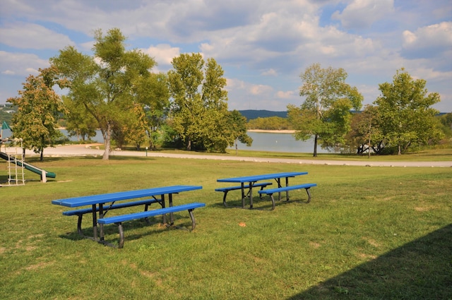 surrounding community featuring a yard and a water view