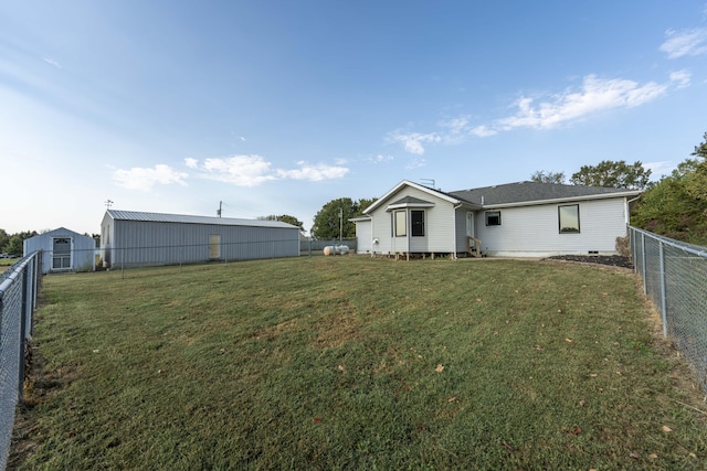 rear view of house featuring a lawn