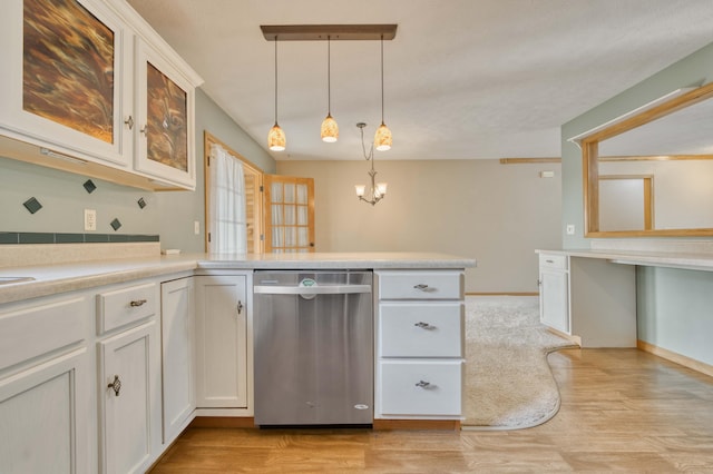 kitchen featuring dishwasher, decorative light fixtures, light wood-type flooring, and white cabinets