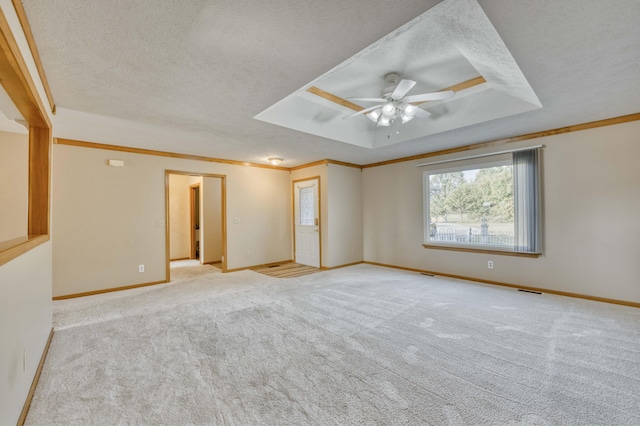 spare room featuring light carpet, crown molding, ceiling fan, and a textured ceiling