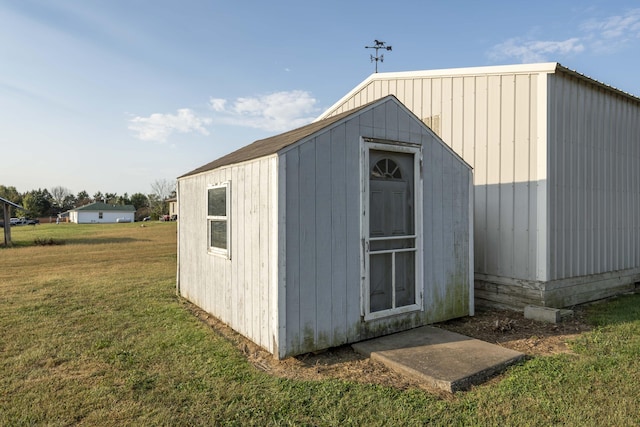 view of outdoor structure featuring a lawn