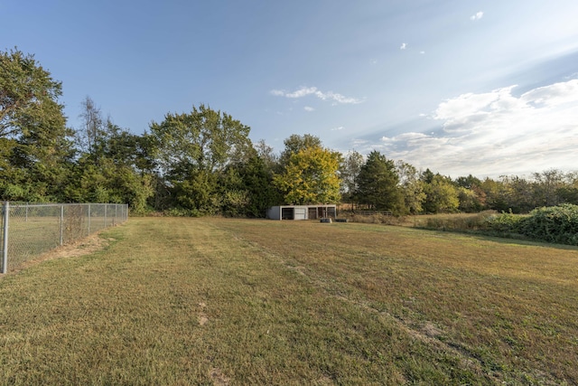 view of yard featuring a rural view and an outdoor structure