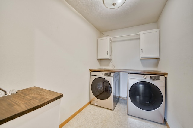 clothes washing area featuring cabinets, independent washer and dryer, and a textured ceiling