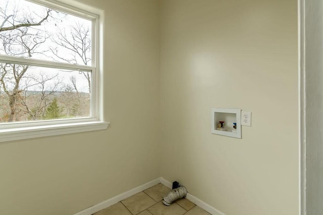 laundry area with light tile patterned floors and washer hookup