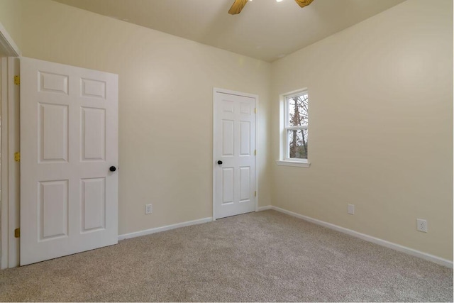 carpeted empty room with ceiling fan