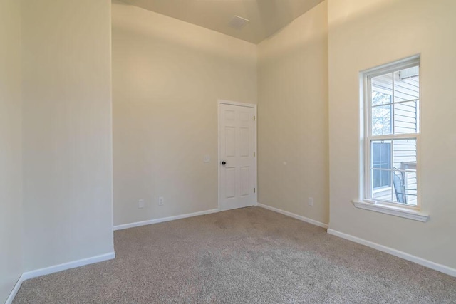 unfurnished room featuring light colored carpet