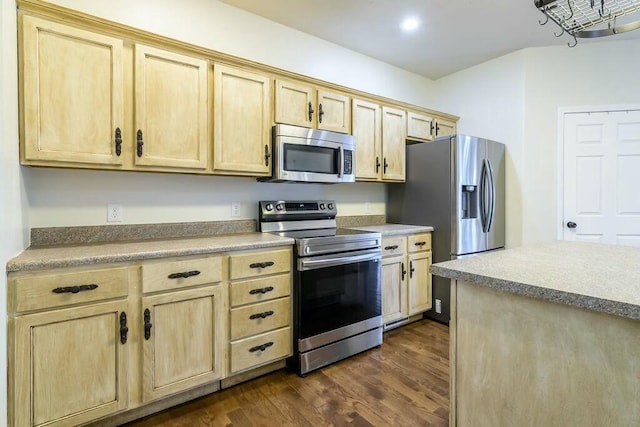 kitchen featuring dark hardwood / wood-style floors, light brown cabinetry, and appliances with stainless steel finishes