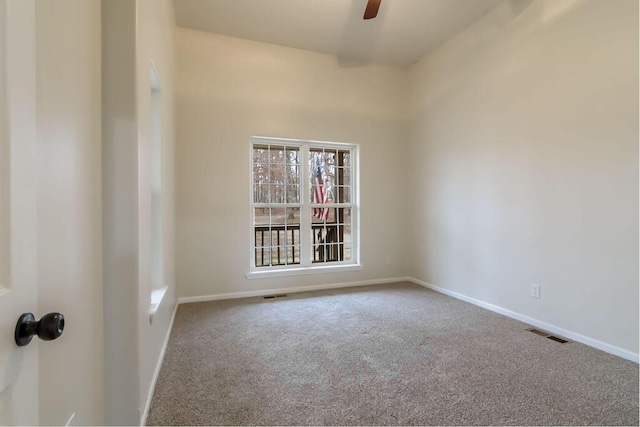 carpeted empty room featuring ceiling fan