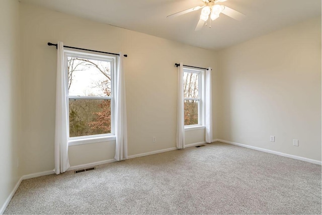 unfurnished room featuring ceiling fan and light colored carpet