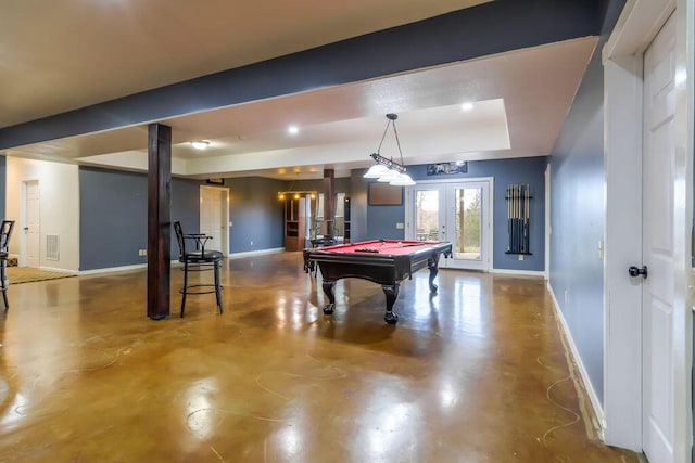 game room with concrete flooring, french doors, a tray ceiling, and billiards