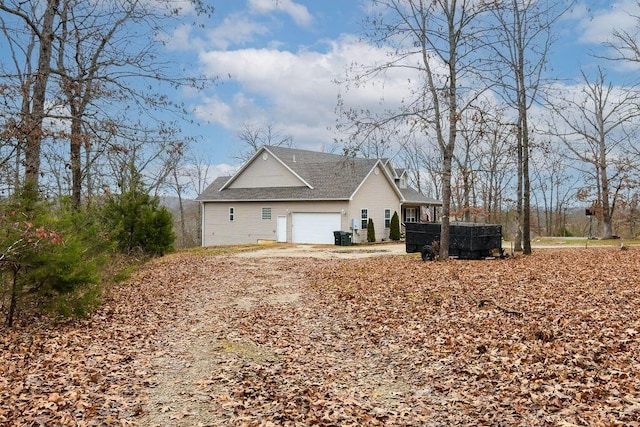 view of side of home featuring a garage