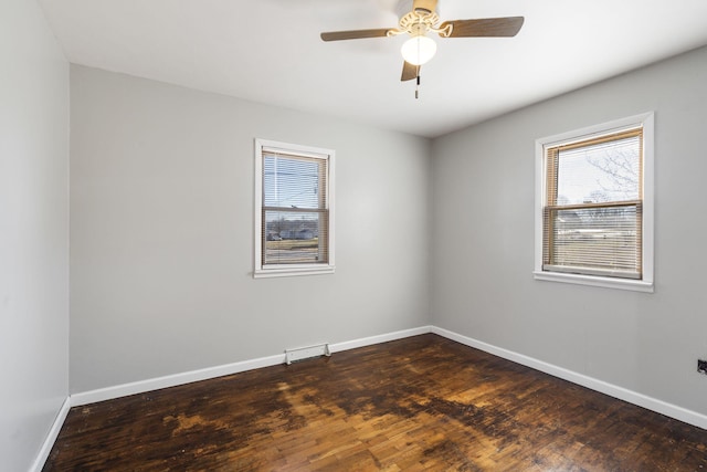 spare room with ceiling fan and dark hardwood / wood-style floors