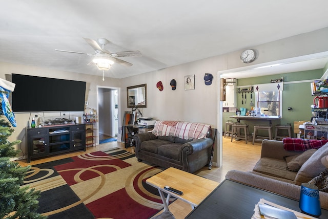 living room featuring ceiling fan and light wood-type flooring