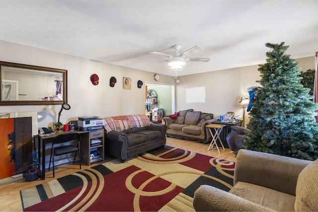 living room with ceiling fan and light hardwood / wood-style flooring