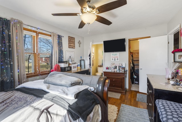 bedroom with ensuite bath, ceiling fan, dark hardwood / wood-style flooring, a walk in closet, and a closet