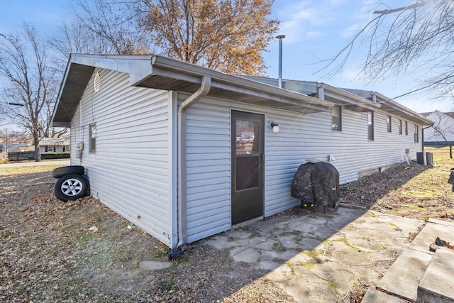 view of side of home featuring central AC