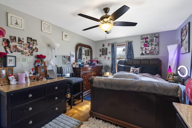 bedroom with ceiling fan and light hardwood / wood-style flooring