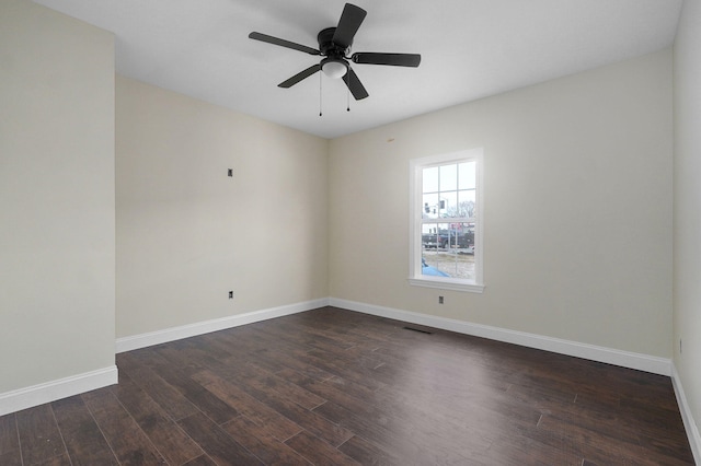 spare room with dark hardwood / wood-style floors and ceiling fan