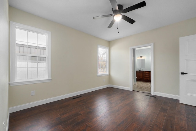 unfurnished bedroom featuring connected bathroom, ceiling fan, dark hardwood / wood-style flooring, and sink