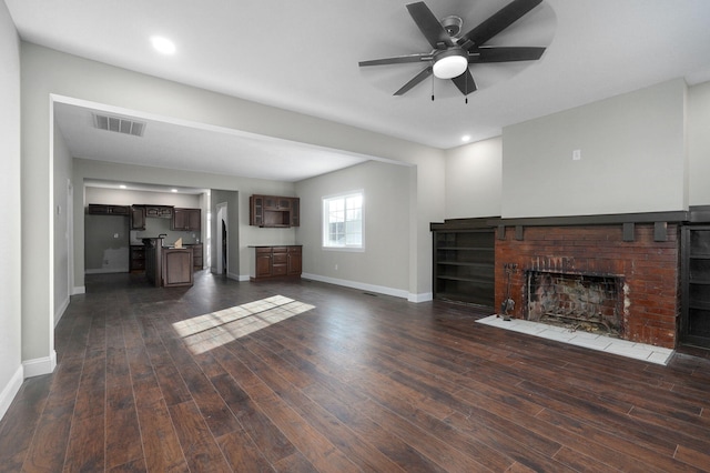 unfurnished living room with ceiling fan, a fireplace, and dark hardwood / wood-style floors