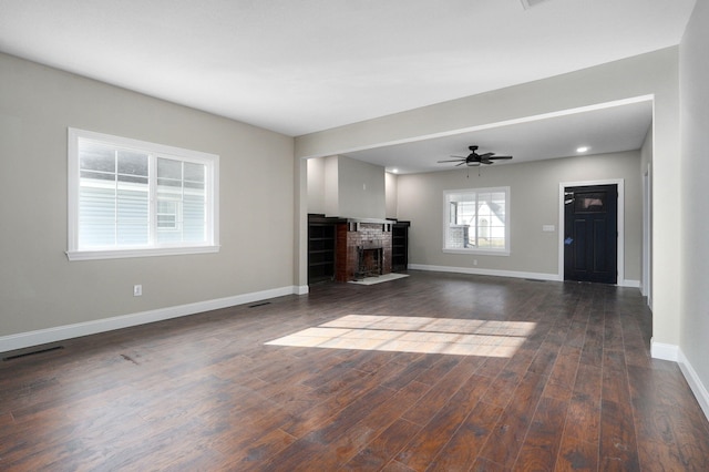 unfurnished living room with ceiling fan and dark hardwood / wood-style flooring