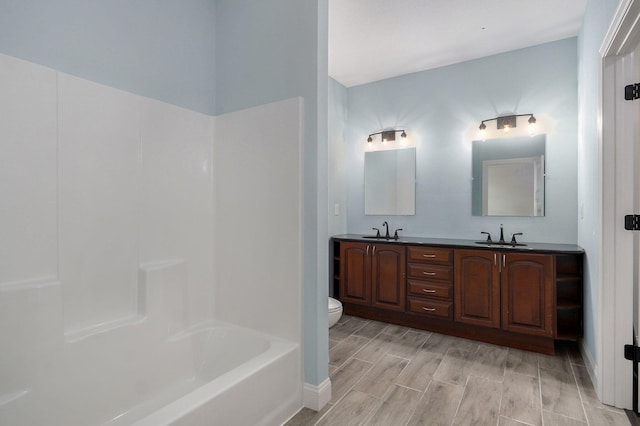 bathroom featuring toilet, vanity, and hardwood / wood-style flooring