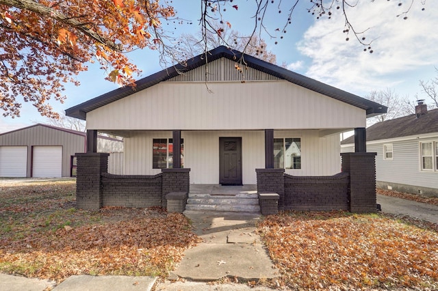 bungalow-style house with an outbuilding, covered porch, and a garage