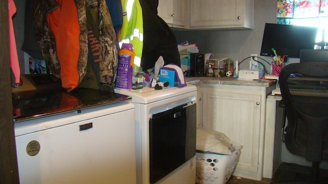 laundry area with cabinets and washing machine and clothes dryer