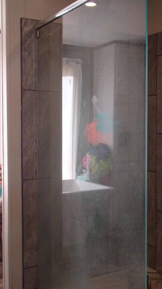 interior details featuring a tile shower